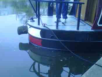 Narrowboat with blacked bottom and new stern paint